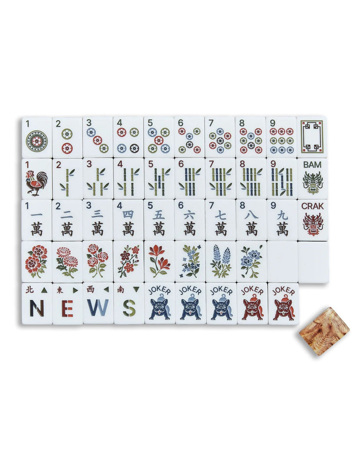 Mahjong tile set showing white acrylic tiles with symbols, dots, and wood-grain backs