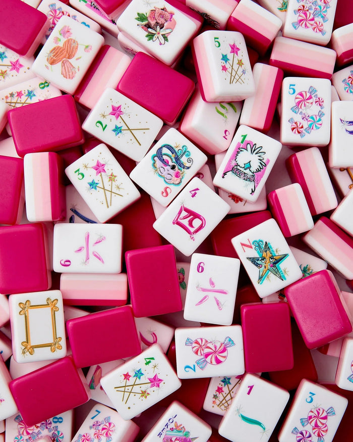 Assorted mahjong tiles: white faces with magenta borders and colorful motifs
