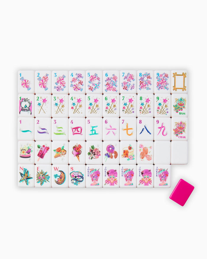 Mahjong tile set laid out on rack: white tiles with pink edges and icons
