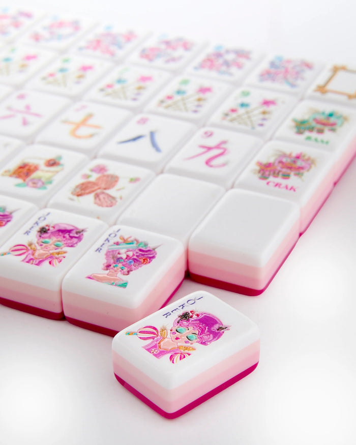 Pink-trimmed white mahjong tiles with colorful illustrated designs