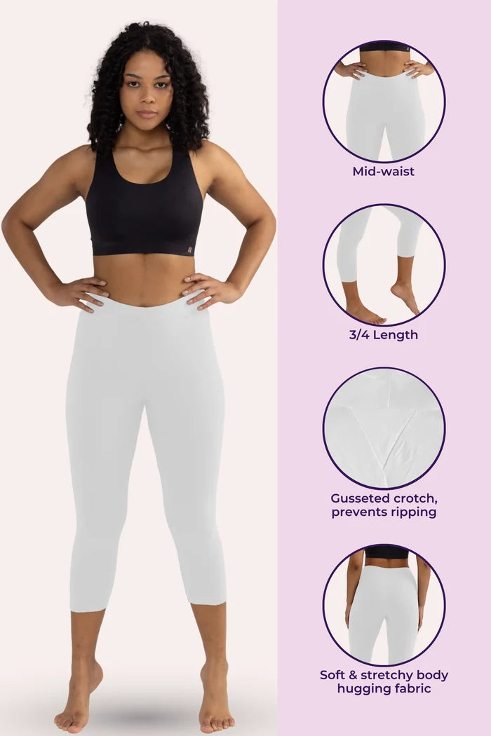 Woman wearing white cropped leggings with product features on a pink background