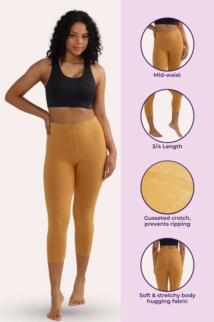 Woman wearing caramel cropped leggings with product features on a pink background