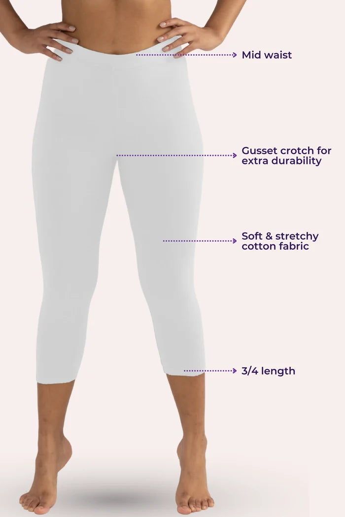 White cropped leggings with text highlighting features on a white background