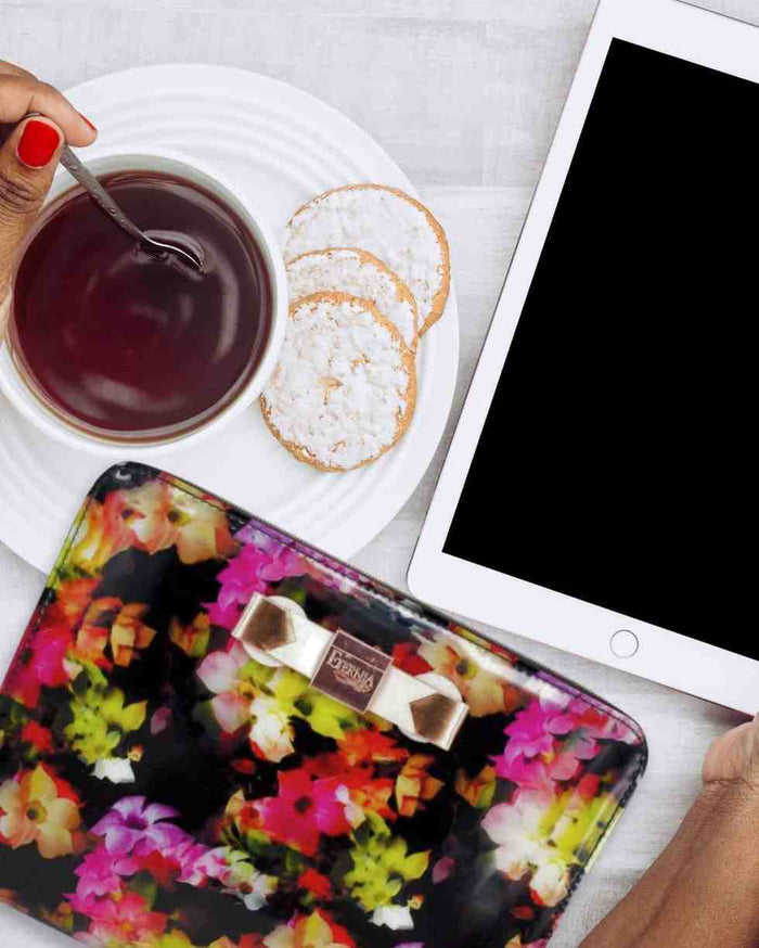 Floral tablet carry bag with black interior and zipper, partially open