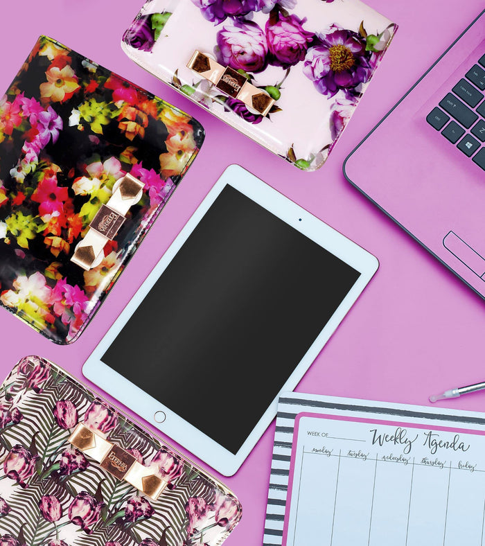 Floral iPad tablet carry bag with gold logo patch and open zipper top