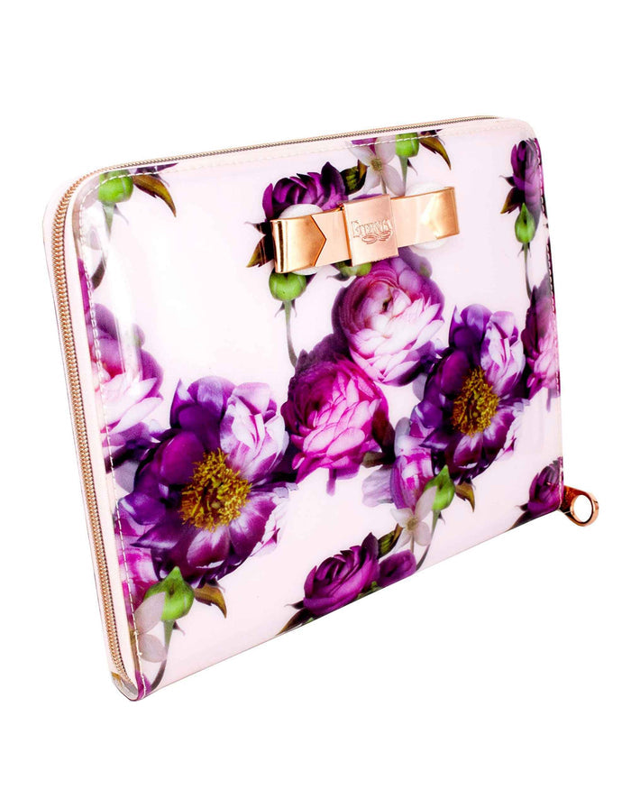 Light pink tablet carry bag with purple floral print, bow clasp, and gold zipper seam