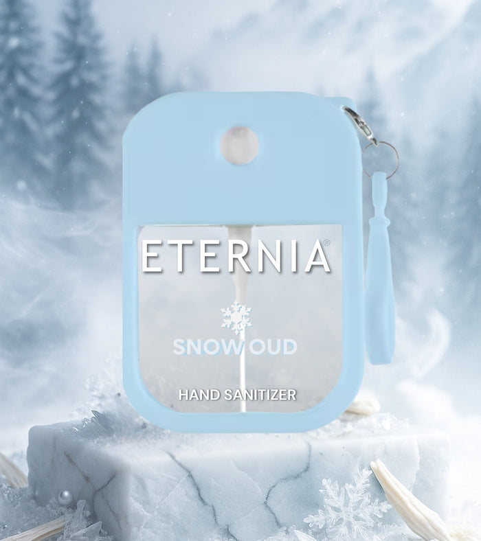 Eternia hand sanitizer keychain spray bottle, light blue front view with Snow Oud label