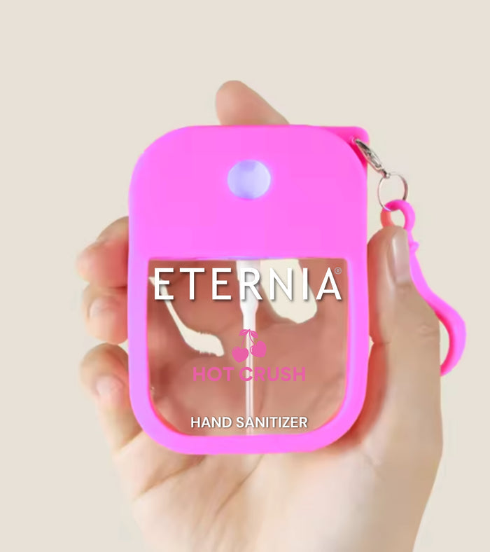 Eternia Hot Crush hand sanitizer spray in pink keyring pouch, held in hand