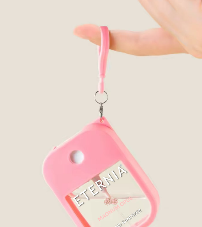 Pink hand sanitizer keyring spray pouch hanging on a metal loop