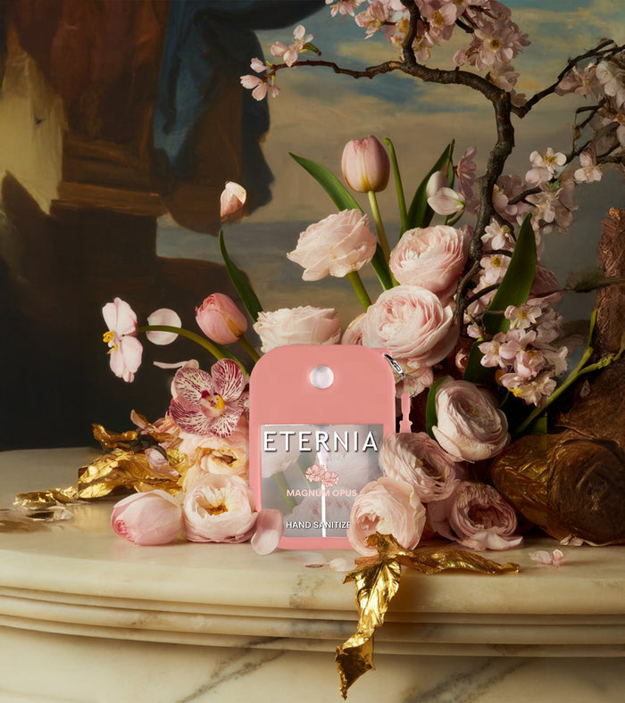 Pink hand sanitizer keyring spray pouch among flowers on a decorative display