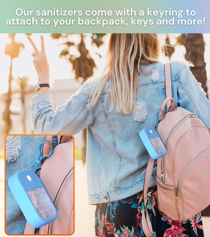 Lilac hand sanitizer spray keychain clipped to a backpack zipper pull