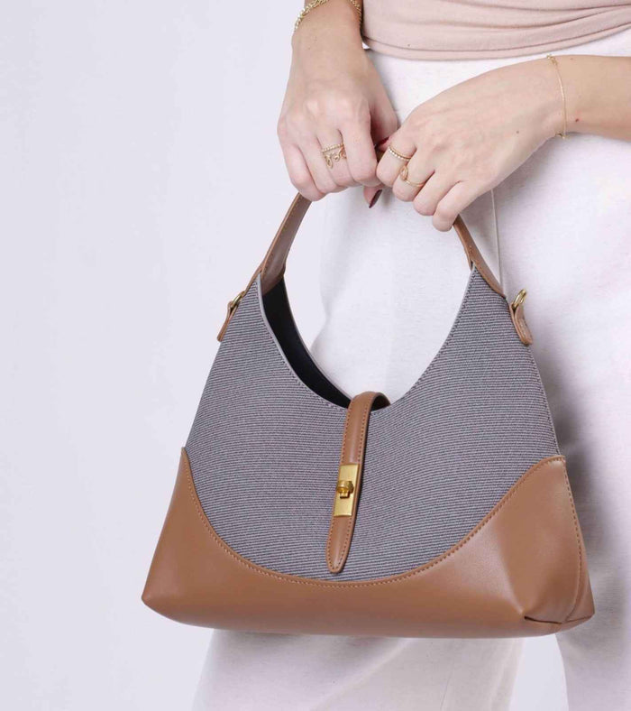 Grey tweed shoulder bag with tan vegan leather trim and gold-tone clasp, top handle