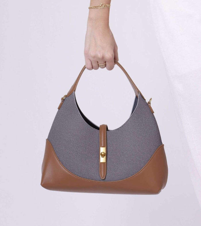 Grey tweed shoulder bag with tan leather trim and gold front clasp, top handles