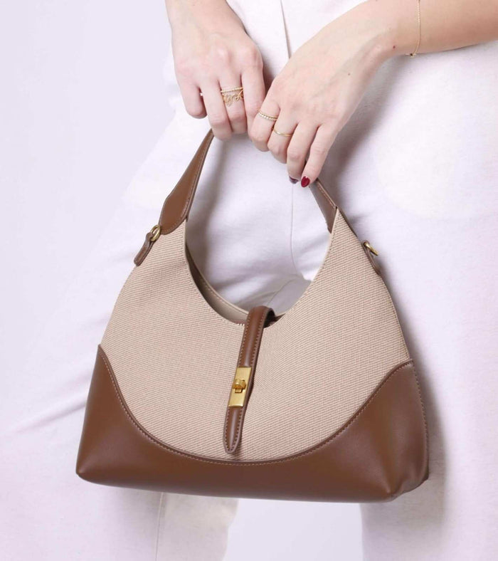 Beige tweed shoulder bag with brown leather trim and center clasp, gold accents