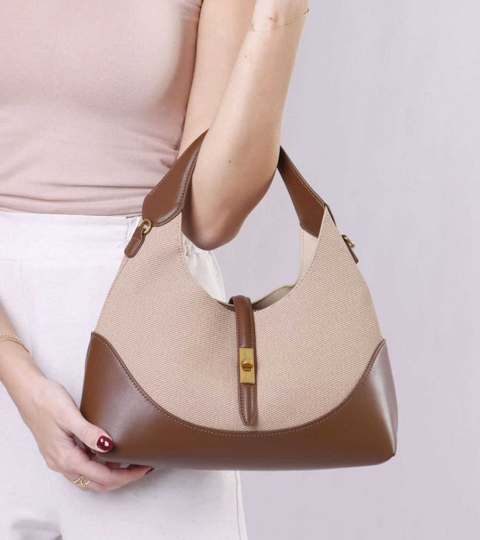 Beige tweed shoulder bag with brown leather panels and gold clasp on front