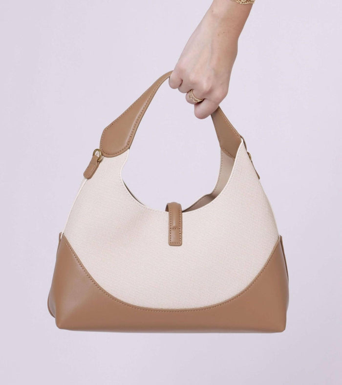 Cream and tan shoulder bag with short strap and long carry strap, gold hardware