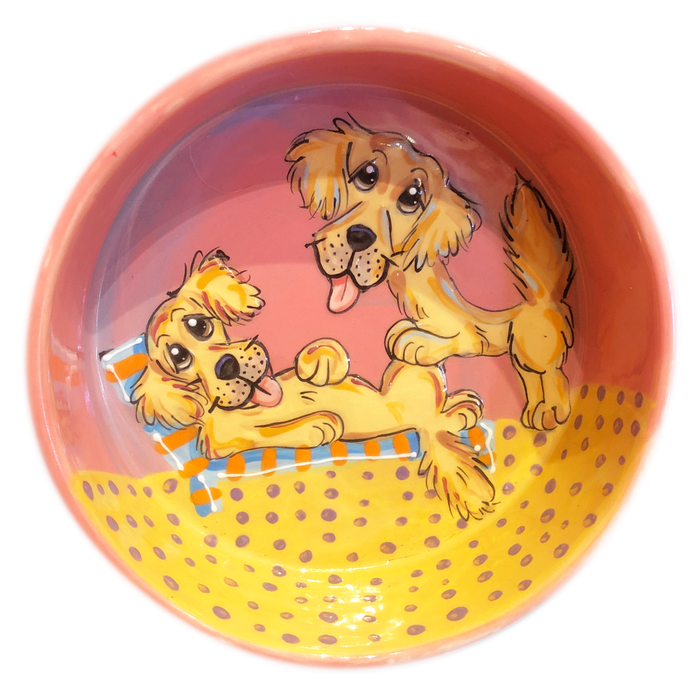 Photo of two golden retrievers hand painted by Debby Carman, on a 8' ceramic dog bowl, pink color background, beach theme
