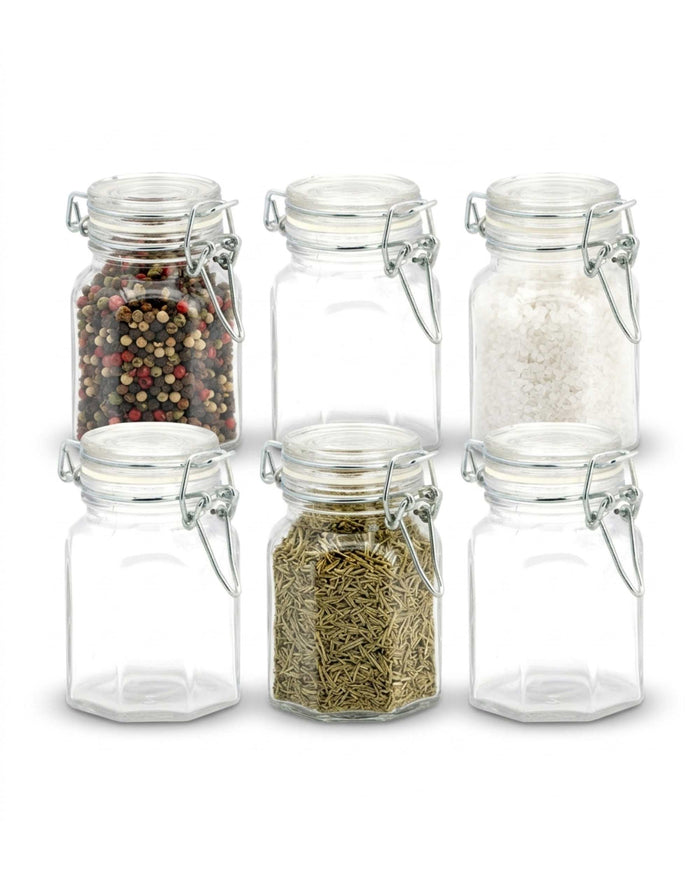 Glass storage jar set with clip-top lids, filled with spices, herbs, and grains