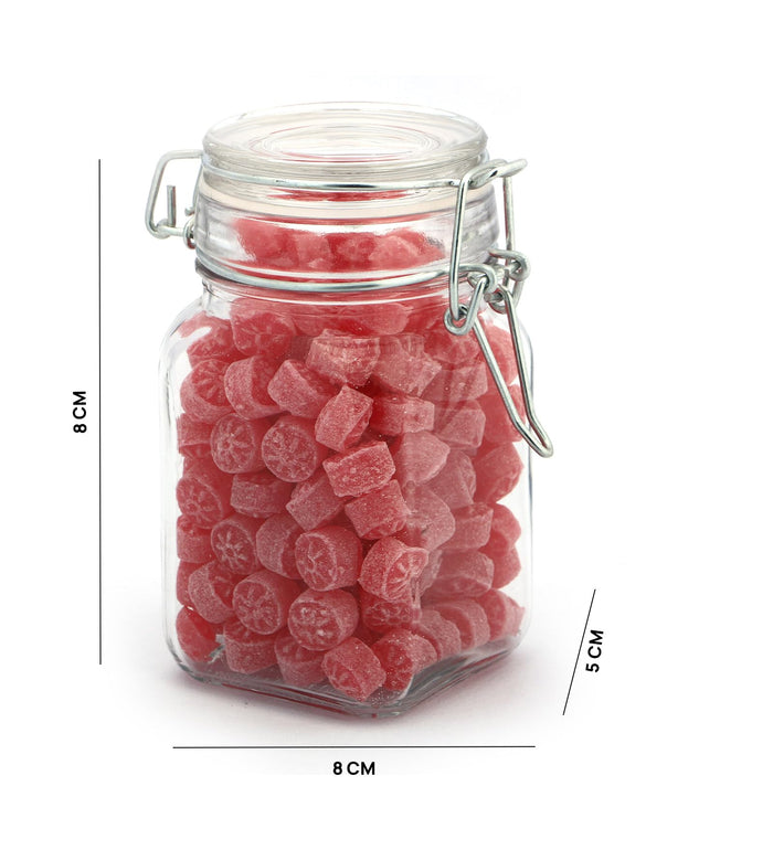 Clear glass storage jar with clip-top lid, filled with red candied fruit