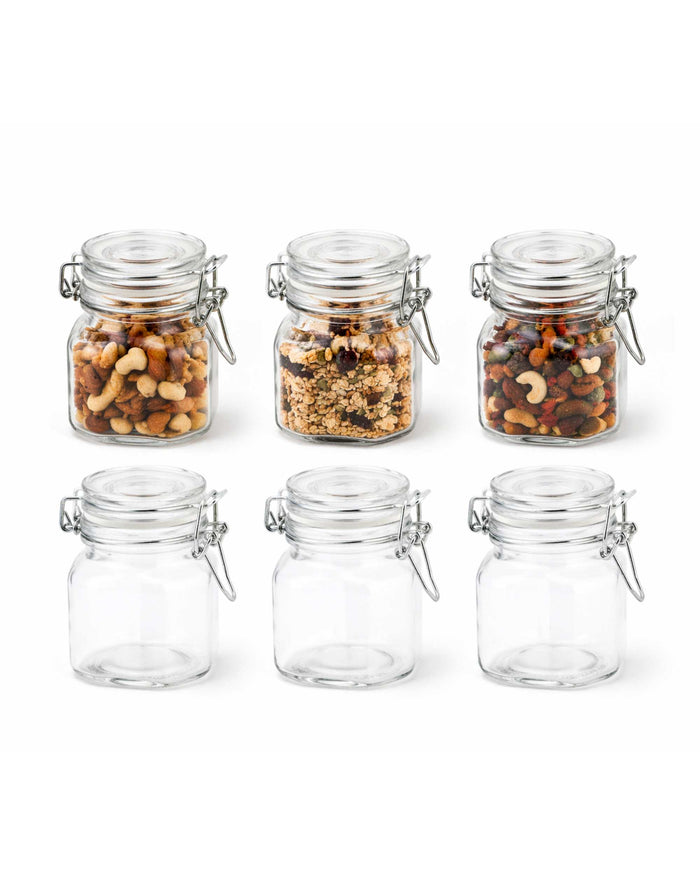Set of airtight square glass jars with clip-top lids, filled and empty