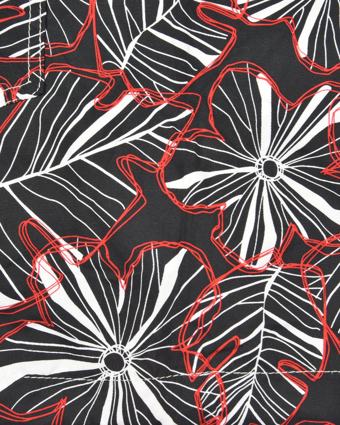Men's swim shorts fabric close-up with black base, white flowers and red outlines