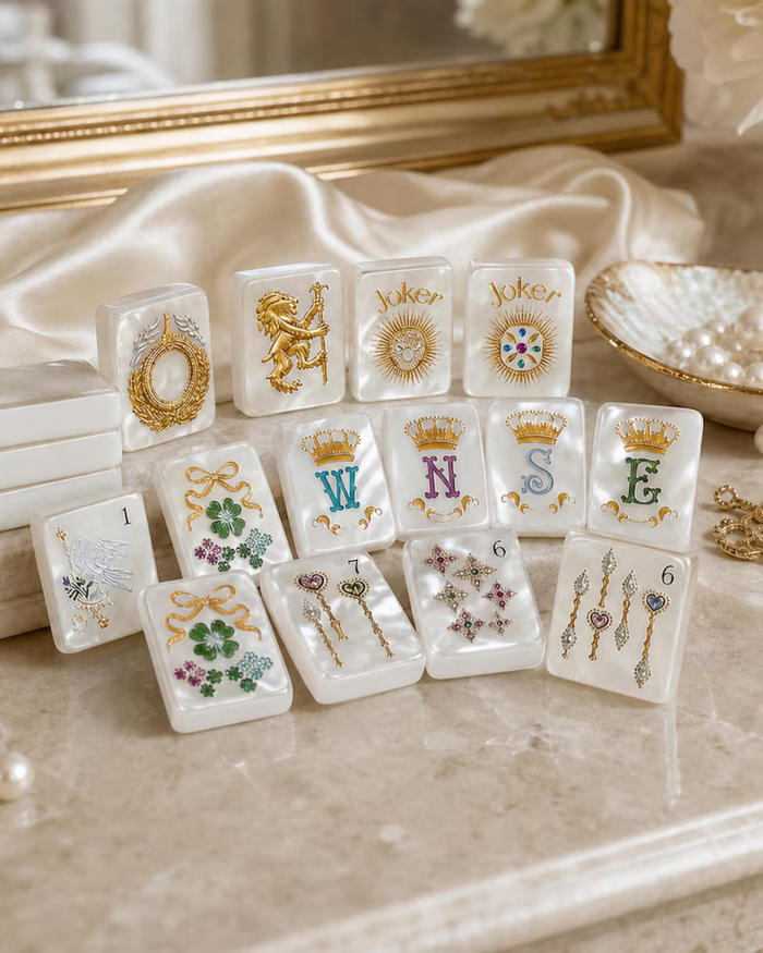 White pearlescent mahjong tiles with gold crown, lion, and “Joker” designs