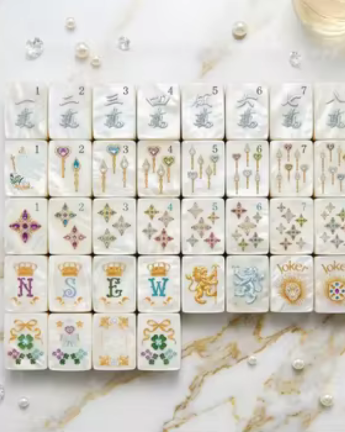 Close-up of mahjong tiles with numbered suits, keys, and ornament details