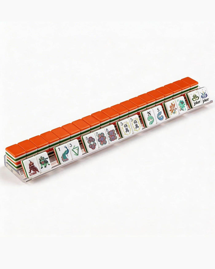 Orange-backed melamine mahjong tile set arranged in a straight row with jokers