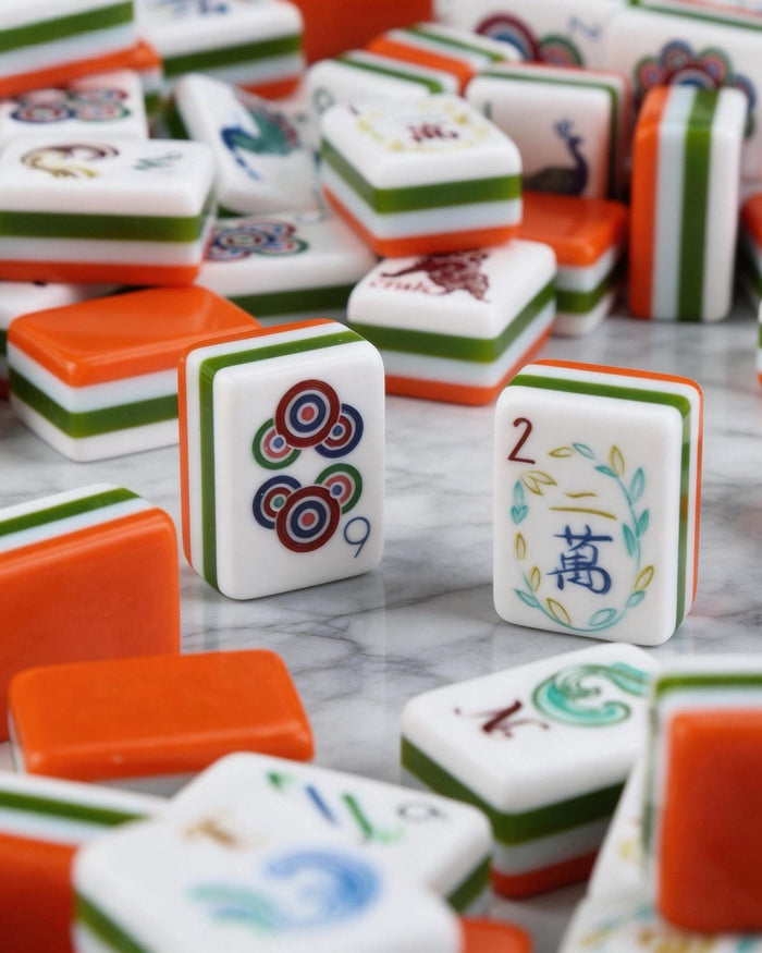 Scattered melamine mahjong tiles in orange and white with suit symbols and joker faces