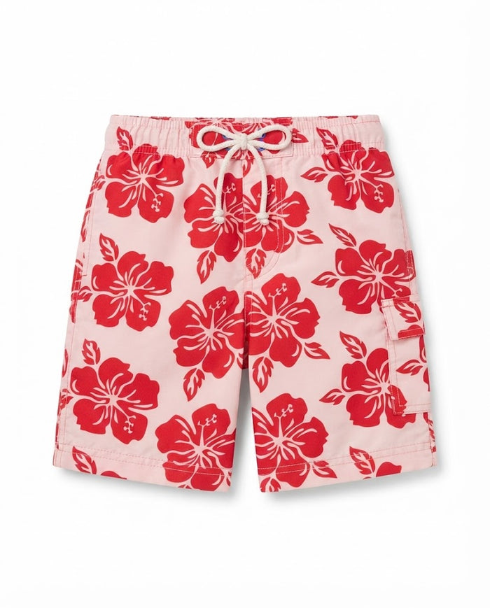 Kids swim shorts in pink with red hibiscus floral print, white drawstring waist