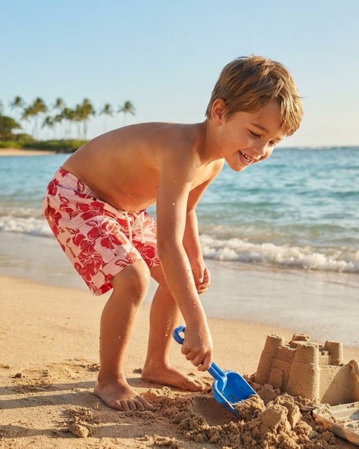 Boys swim trunks, pink with red hibiscus floral print and white drawstring waist