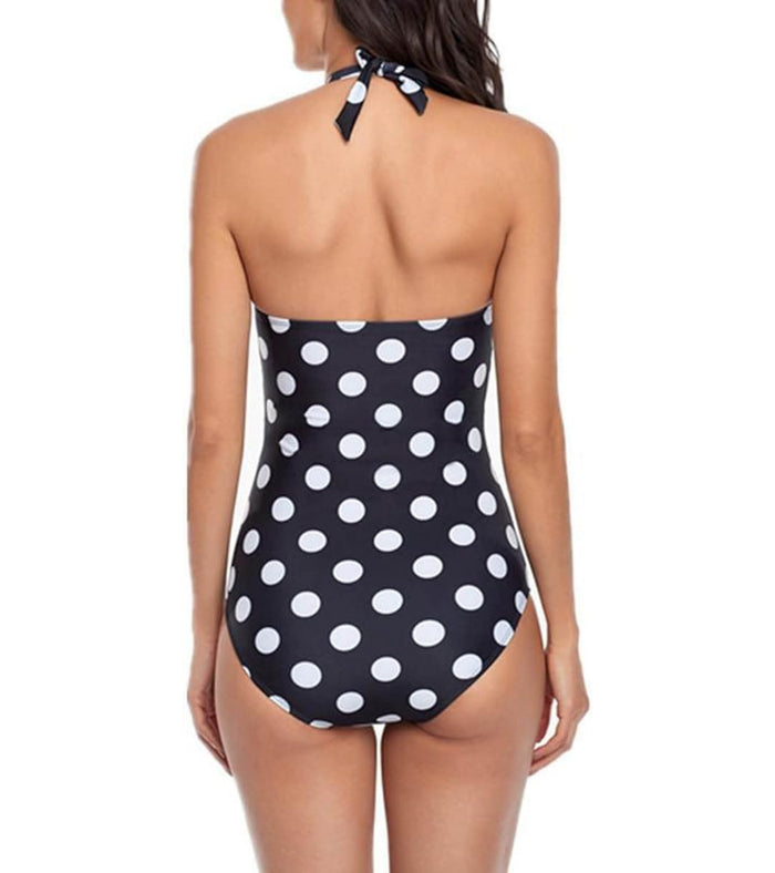 Women's one-piece swimsuit back view, halter tie neck, black/white polka dots.